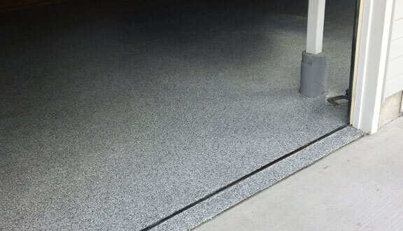 This image shows a garage floor with flake epoxy painted floor.