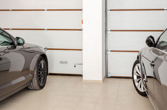 This image shows a garage with 2 cars parked.