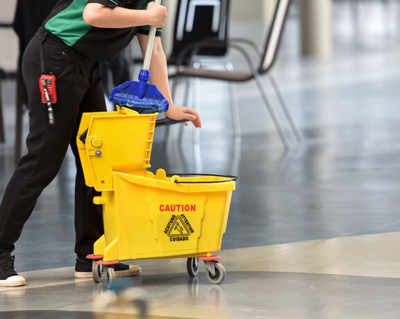 This image shows a man mopping the floor.