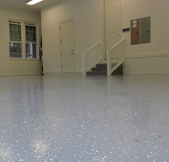 This image shows a garage floor with flake epoxy painted floor.
