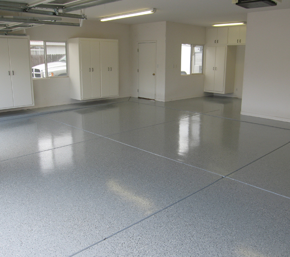 This image shows a garage floor with flake epoxy painted floor.