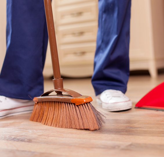 Wood Stamped Concrete This image shows a man sweeping the floor.