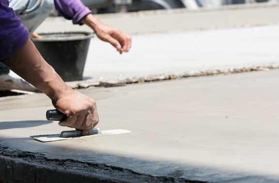 This image shows a man resurfacing a cement floor.