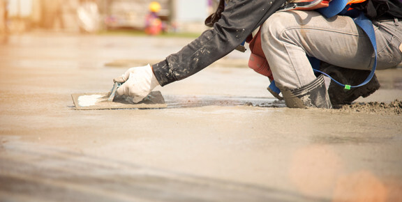 This image shows a man resurfacing a cement floor.