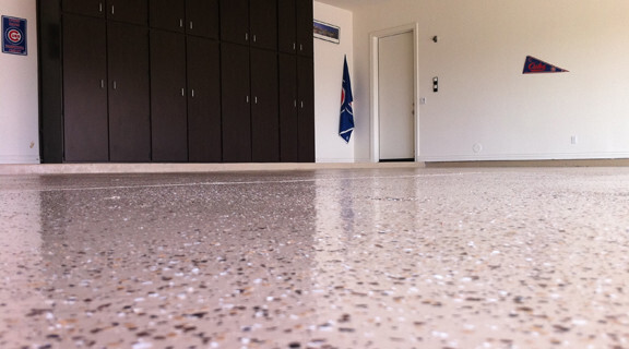This image shows a garage floor with flake epoxy painted floor.