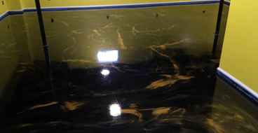 metallic epoxy This image shows an living room with metallic epoxy floor.