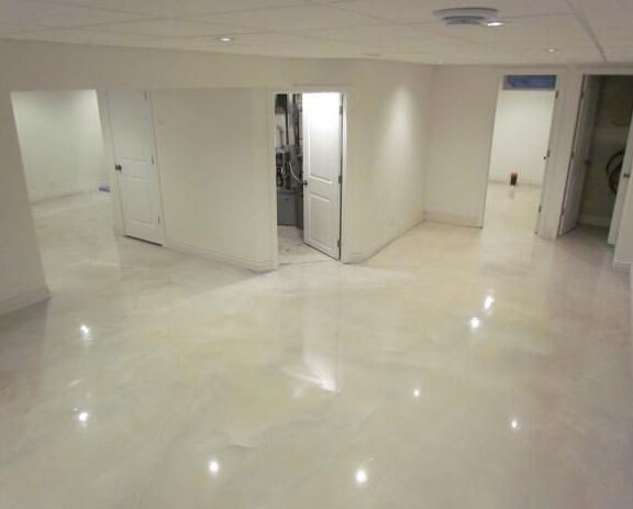 This image shows a Basement Floor with white metallic epoxy paint.